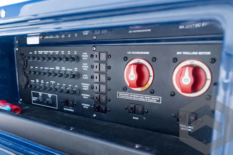 Slide: The Image of Control panel of 2026 Pathfinder 2200 TRS boat, featuring switches and dials. - 65