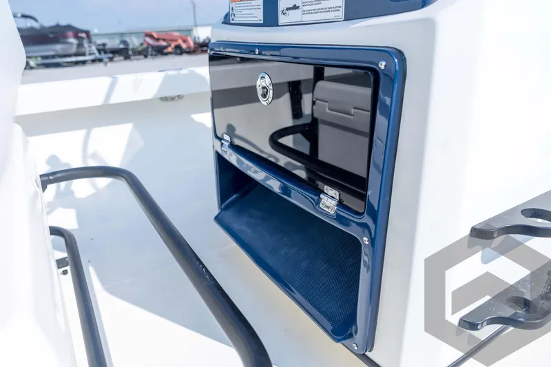 Slide: The Image of 2026 Pathfinder 2200 TRS boat console with storage compartment and rod holders. - 66