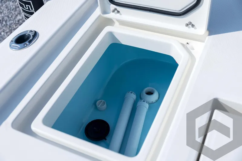 Slide: The Image of Livewell compartment of 2026 Pathfinder 2200 TRS boat, featuring blue interior and drainage system. - 72