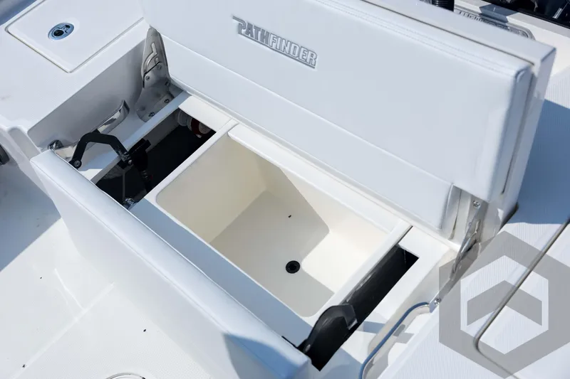 Slide: The Image of 2026 Pathfinder 2200 TRS boat storage compartment with open lid, showcasing interior features. - 74