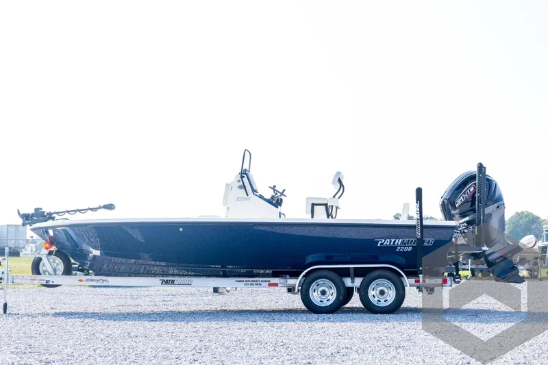 Slide: The Image of 2026 Pathfinder 2200 TRS boat on trailer, side view, outdoors on gravel. - 8