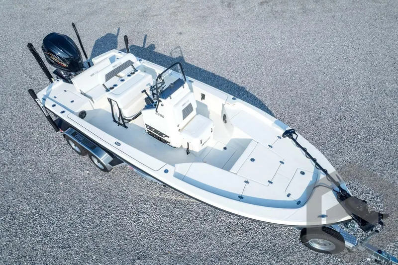 Slide: The Image of 2026 Pathfinder 2200 TRS boat on trailer, aerial view, parked on gravel surface. - 83