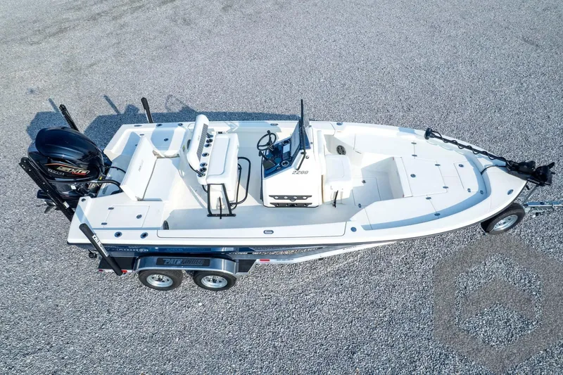Slide: The Image of 2026 Pathfinder 2200 TRS boat on trailer, aerial view, parked on gravel surface. - 84