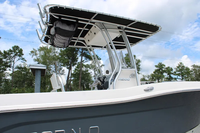 Slide: The Image of 2018 Robalo R200 Center Console boat with T-top, parked outdoors. - 15