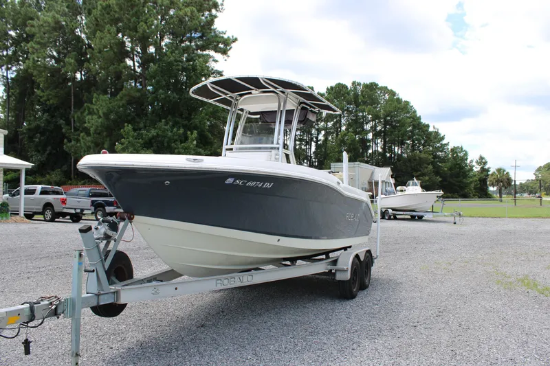 Slide: The Image of 2018 Robalo R200 Center Console boat on trailer in outdoor setting. - 2
