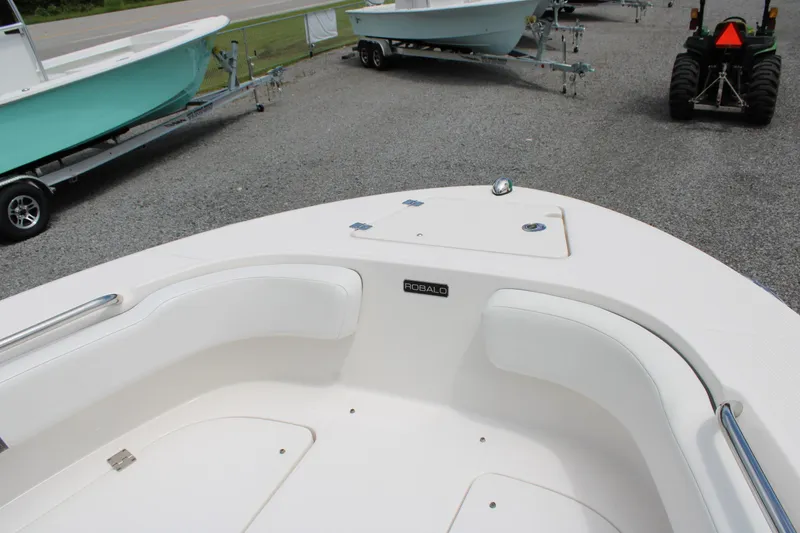 Slide: The Image of 2018 Robalo R200 Center Console boat interior with white seating and storage compartments. - 28
