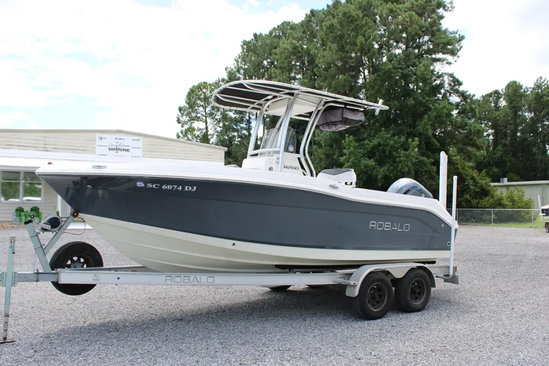 Slide: The Image of 2018 Robalo R200 Center Console boat on trailer, parked outdoors. - 3