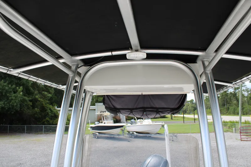 Slide: The Image of 2018 Robalo R200 Center Console boat with T-top, parked outdoors. - 31