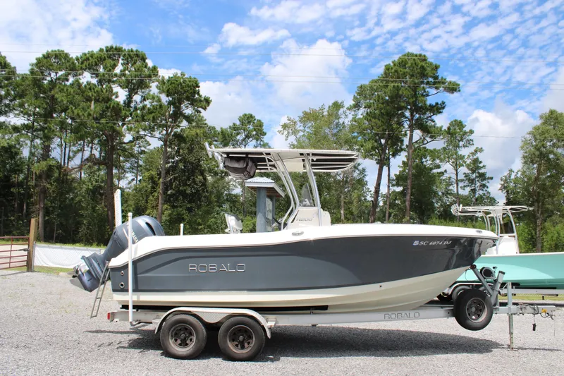 Slide: The Image of 2018 Robalo R200 Center Console boat on trailer, parked outdoors. - 36