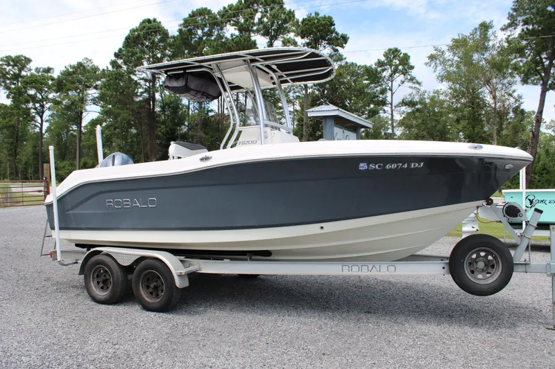 Slide: The Image of 2018 Robalo R200 Center Console boat on trailer, parked outdoors. - 5
