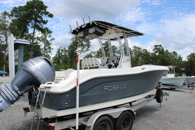 Slide: The Image of 2018 Robalo R200 Center Console boat on trailer, parked outdoors. - 9