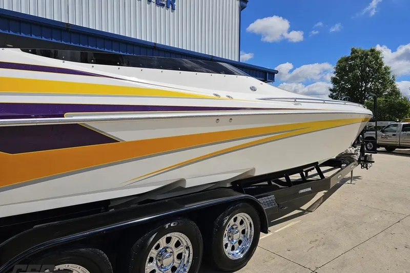 Slide: The Image of 2008 Nordic Powerboats 35 Flame MCOB with vibrant yellow and purple accents on trailer. - 10