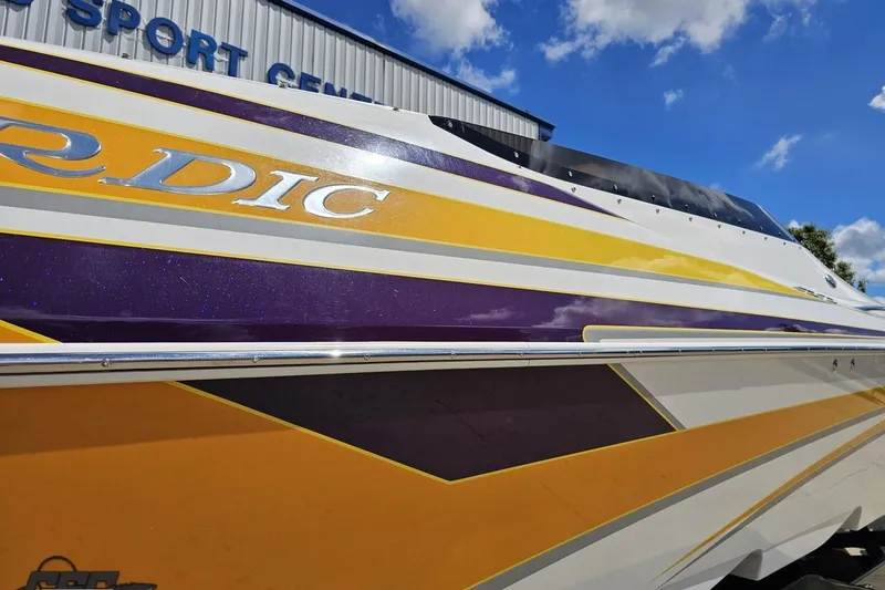 Slide: The Image of 2008 Nordic Powerboats 35 Flame MCOB with vibrant yellow and purple design under blue sky. - 12