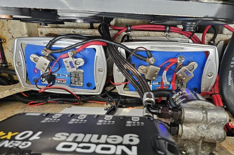 Slide: The Image of 2008 Nordic Powerboats 35 Flame MCOB battery compartment with NOCO Genius charger and wiring. - 125