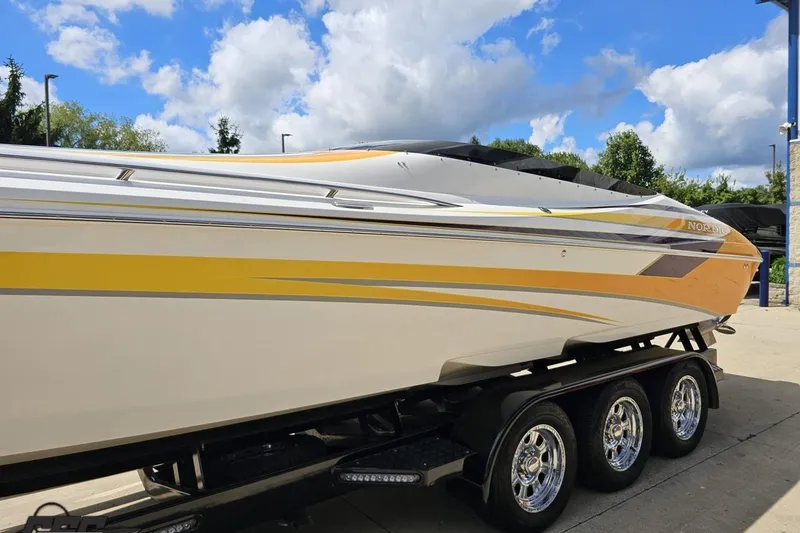 Slide: The Image of 2008 Nordic Powerboats 35 Flame MCOB on trailer, featuring sleek yellow and white design. - 25