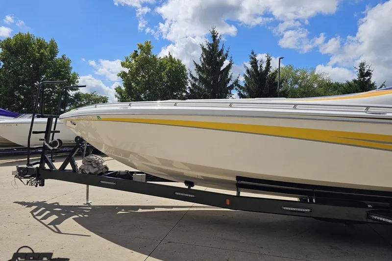 Slide: The Image of 2008 Nordic Powerboats 35 Flame MCOB on trailer, under blue sky with trees. - 26