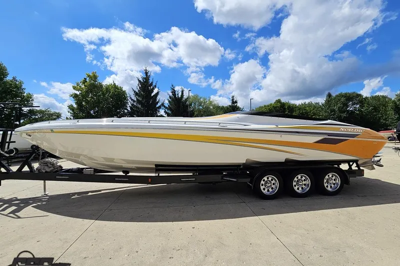 Slide: The Image of 2008 Nordic Powerboats 35 Flame MCOB on trailer under blue sky. - 27