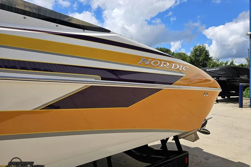 Slide: The Image of 2008 Nordic Powerboats 35 Flame MCOB with vibrant yellow and purple design under blue sky. - 29