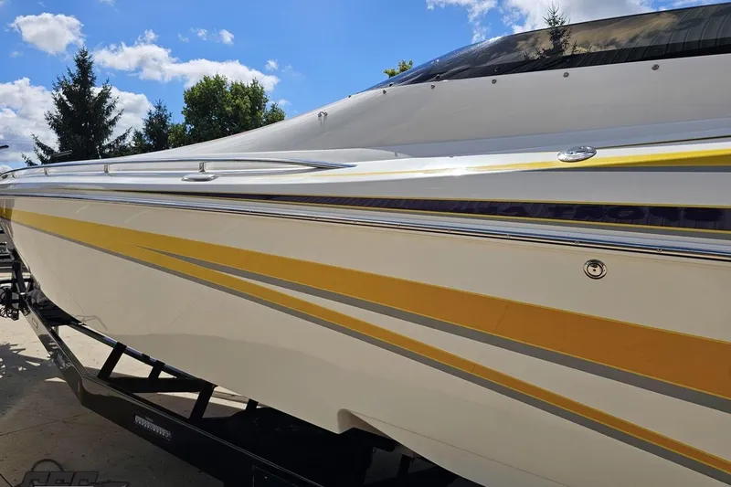 Slide: The Image of 2008 Nordic Powerboats 35 Flame MCOB with yellow accents under a clear blue sky. - 30