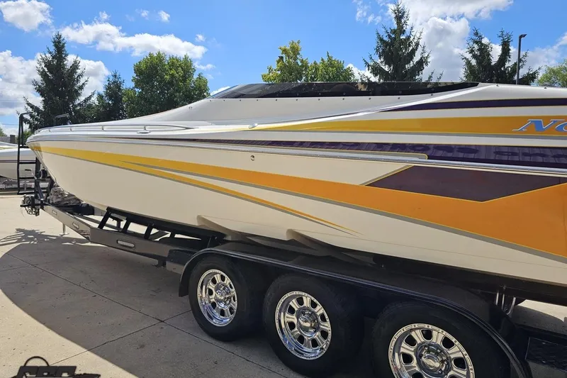 Slide: The Image of 2008 Nordic Powerboats 35 Flame MCOB on trailer, featuring sleek yellow and white design. - 31