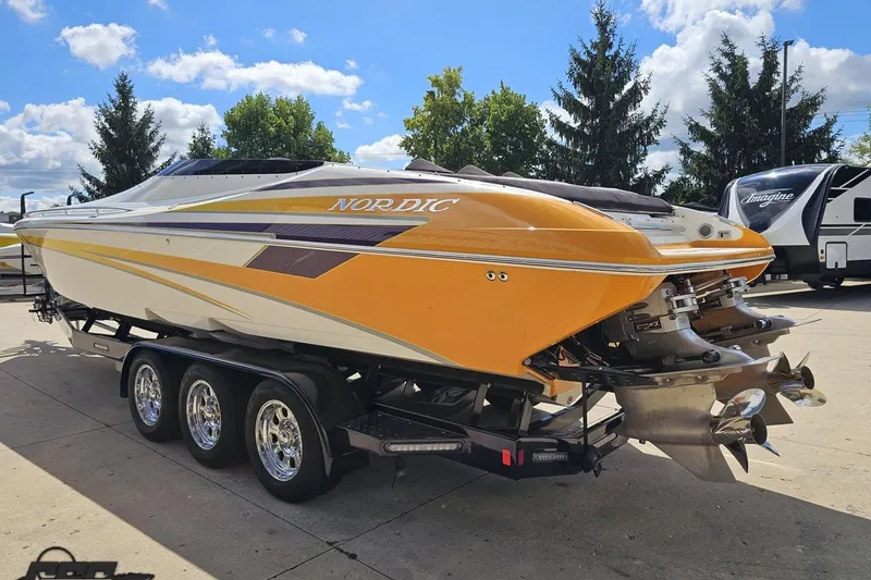 Slide: The Image of 2008 Nordic Powerboats 35 Flame MCOB on trailer, vibrant yellow design, parked outdoors. - 33