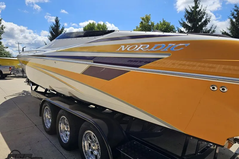Slide: The Image of 2008 Nordic Powerboats 35 Flame MCOB on trailer, vibrant yellow and white design. - 34
