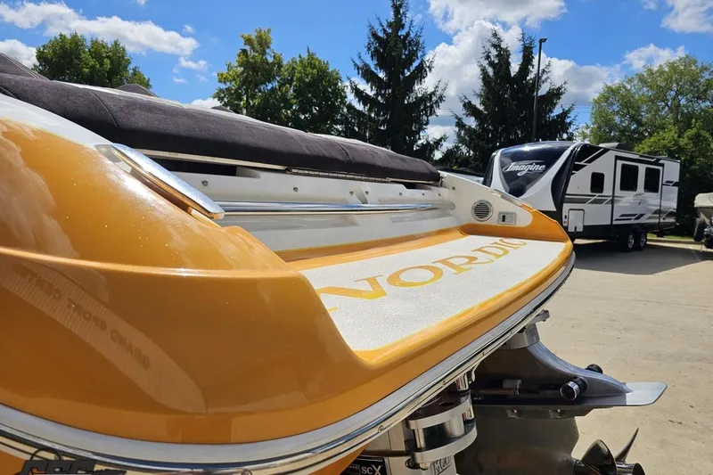 Slide: The Image of 2008 Nordic Powerboats 35 Flame MCOB, vibrant yellow, parked outdoors with RV in background. - 35