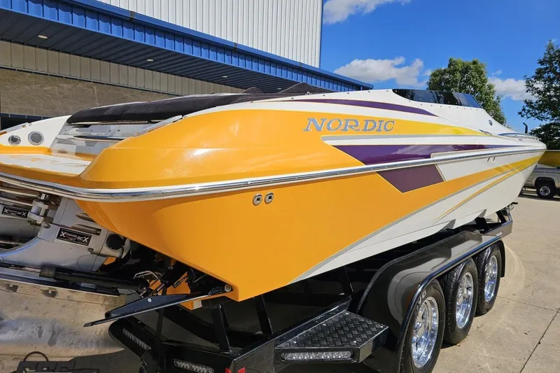Slide: The Image of 2008 Nordic Powerboats 35 Flame MCOB in vibrant yellow and purple on a trailer. - 40
