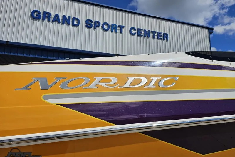 Slide: The Image of 2008 Nordic Powerboats 35 Flame MCOB at Grand Sport Center, vibrant yellow and purple design. - 42