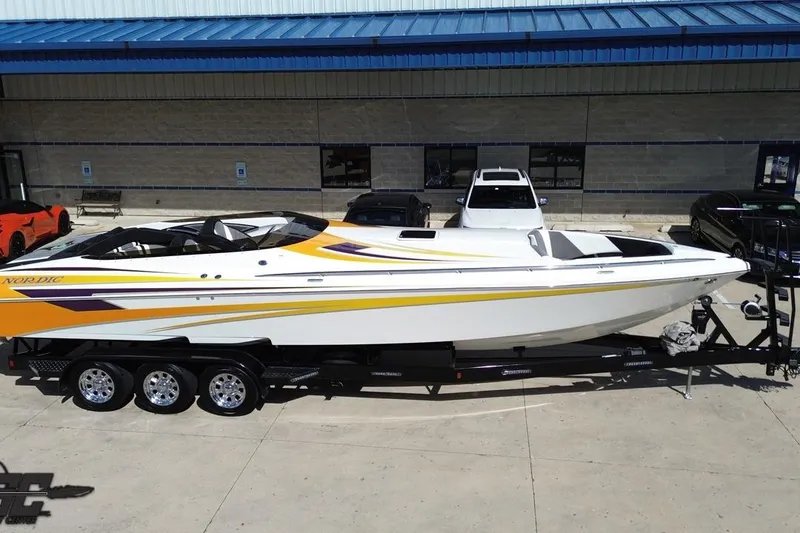 Slide: The Image of 2008 Nordic Powerboats 35 Flame MCOB on trailer, vibrant yellow and white design. - 43