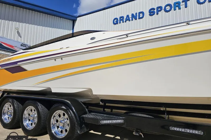 Slide: The Image of 2008 Nordic Powerboats 35 Flame MCOB with vibrant yellow and purple accents on trailer. - 5