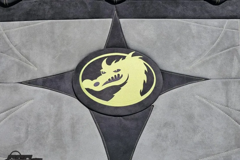 Slide: The Image of 2008 Nordic Powerboats 35 Flame MCOB interior with dragon emblem on gray upholstery. - 53