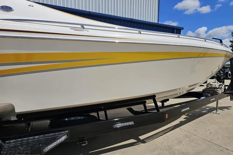 Slide: The Image of 2008 Nordic Powerboats 35 Flame MCOB with yellow accents on a trailer, under blue sky. - 7