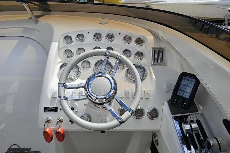 Slide: The Image of 2008 Nordic Powerboats 35 Flame MCOB dashboard with steering wheel and gauges. - 74