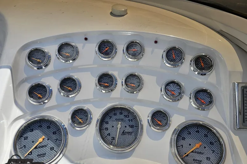 Slide: The Image of Dashboard of 2008 Nordic Powerboats 35 Flame MCOB with multiple gauges and dials. - 77