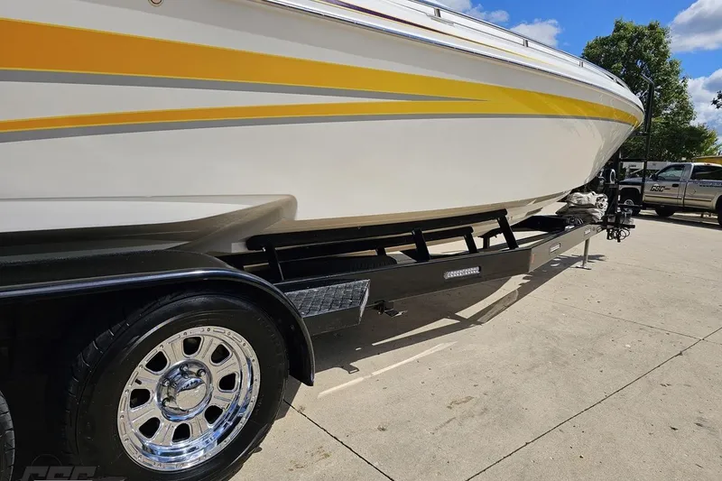 Slide: The Image of 2008 Nordic Powerboats 35 Flame MCOB on trailer, featuring yellow accents and chrome wheels. - 8