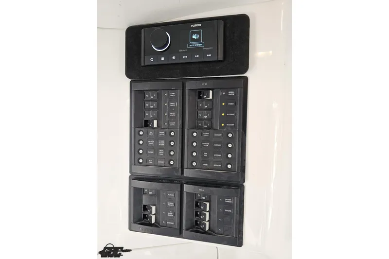 Slide: The Image of Control panel of 2008 Nordic Powerboats 35 Flame MCOB with audio system and switches. - 93