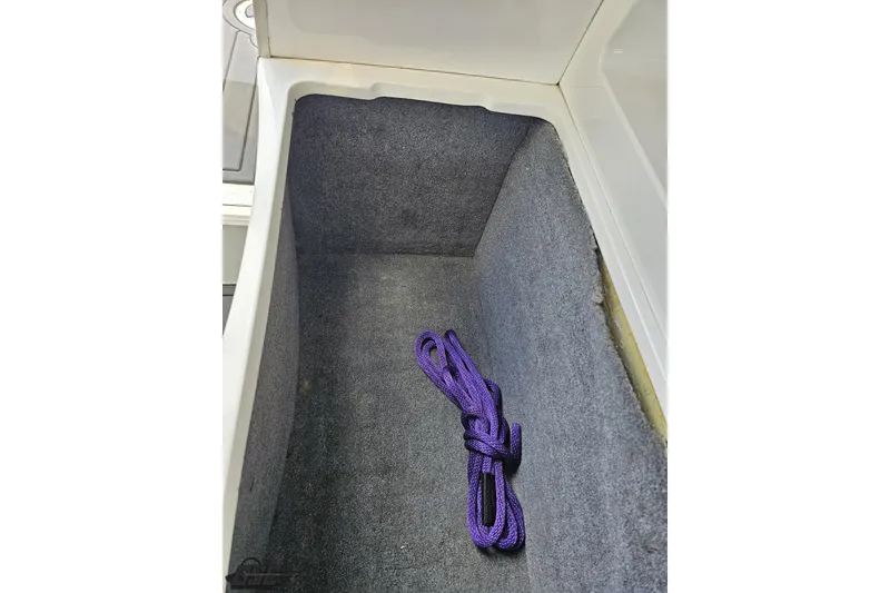 Slide: The Image of Storage compartment of 2008 Nordic Powerboats 35 Flame MCOB with purple rope. - 97