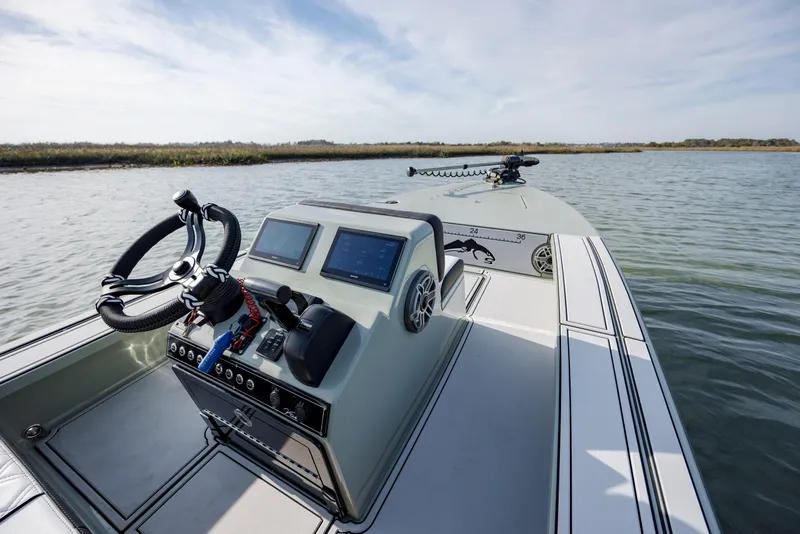 Slide: The Image of Modern Vtech 18 boat dashboard, 2025 model, on calm water with clear sky. - 12
