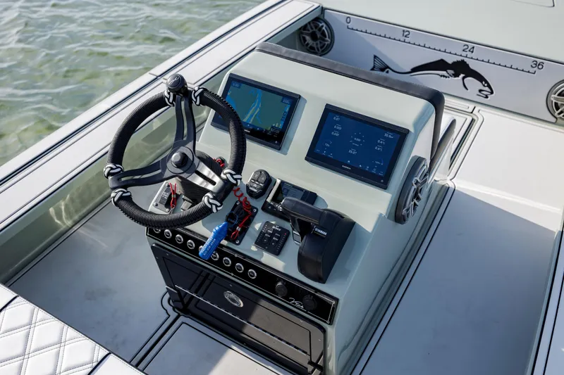 Slide: The Image of Steering console of 2025 Vtech 18 boat with dual screens and controls. - 13