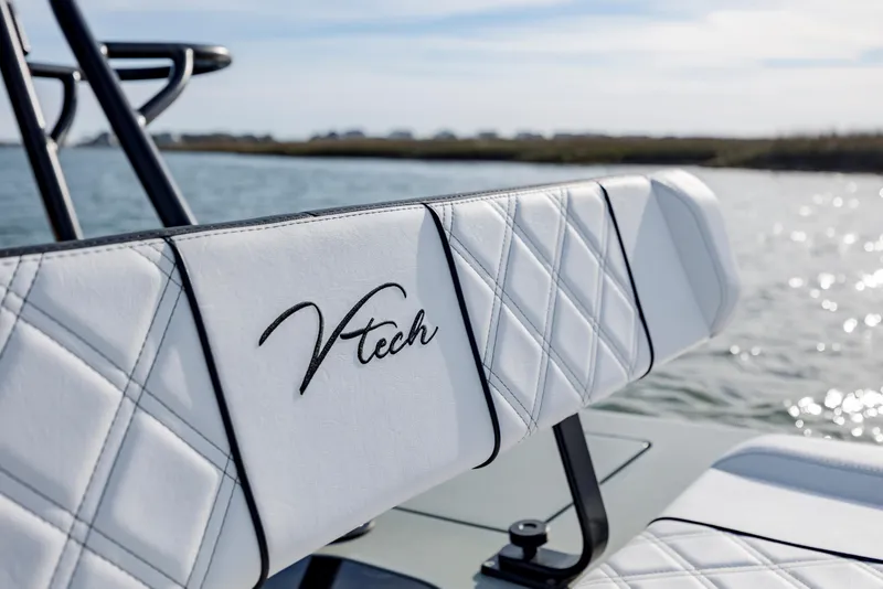 Slide: The Image of White Vtech 18 boat seat with diamond stitching, 2025 model, by the water. - 18