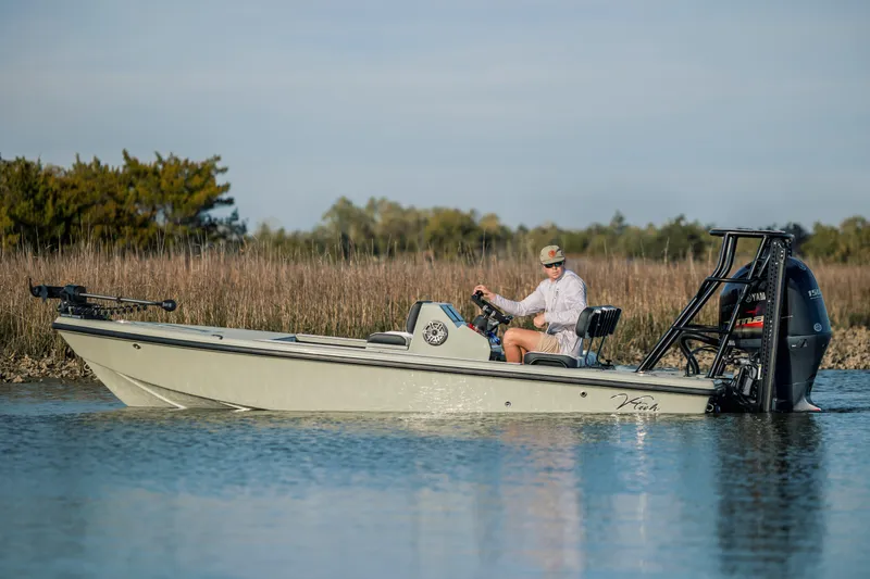Slide: The Image of A person operates a 2025 Vtech 18 boat on a calm waterway. - 2