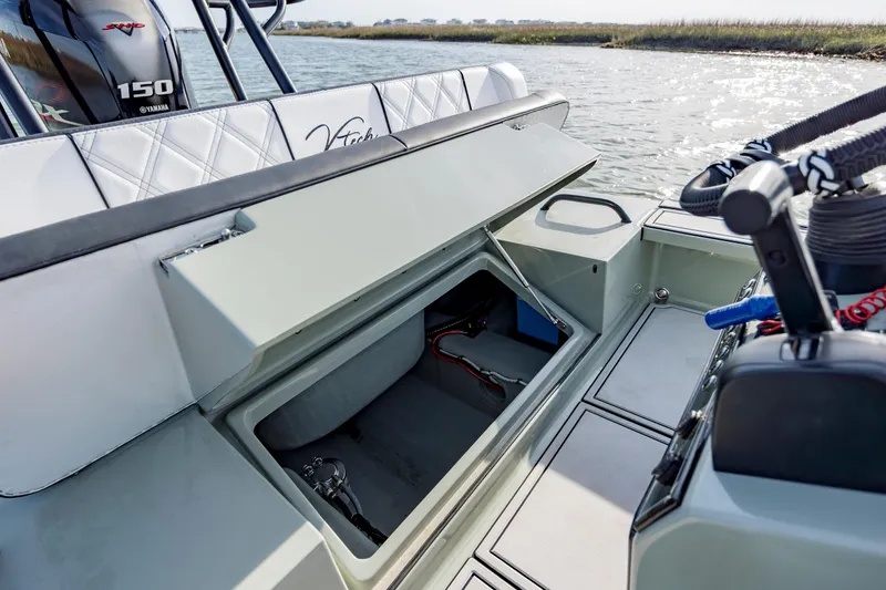 Slide: The Image of Open storage compartment on a 2025 Vtech 18 boat, near water. - 20