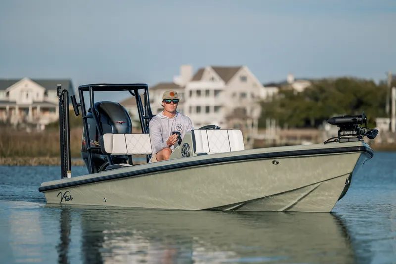 Slide: The Image of Man on Vtech 18 boat, 2025 model, cruising near coastal homes. - 3