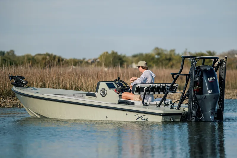 Slide: The Image of 2025 Vtech 18 boat on water, person steering, Yamaha motor, natural background. - 4