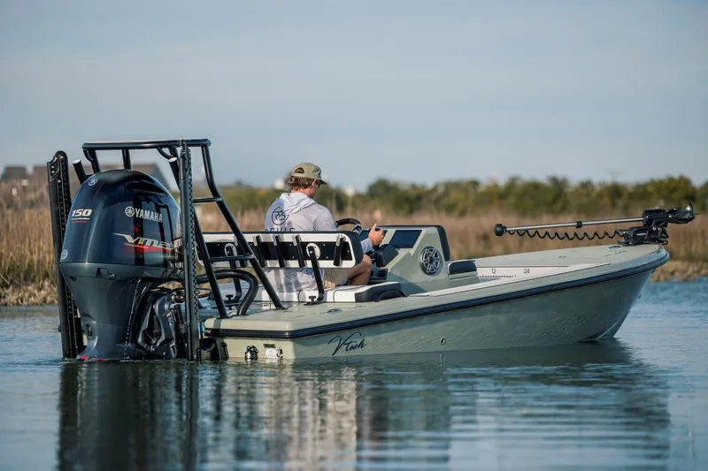 Slide: The Image of Man operating Vtech 18 boat with Yamaha engine on calm water, 2025 model. - 6