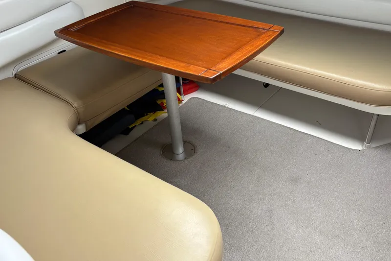 Slide: The Image of Interior seating area of 1995 Sea Ray 370 Sundancer with wooden table. - 10