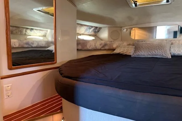 Slide: The Image of Cozy interior cabin of 1995 Sea Ray 370 Sundancer with bed and mirror. - 11
