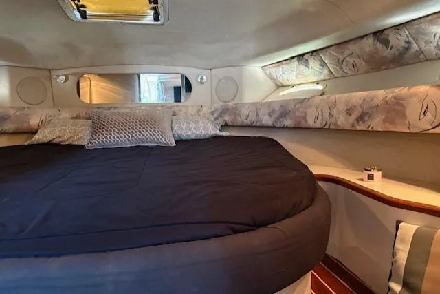 Slide: The Image of Interior cabin of 1995 Sea Ray 370 Sundancer with cozy bed and pillows. - 12