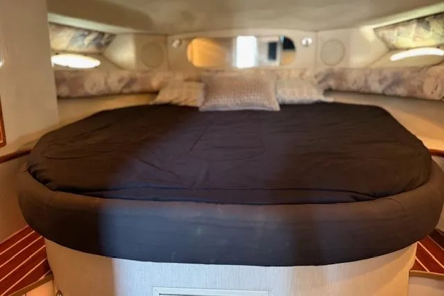 Slide: The Image of Cozy cabin interior of 1995 Sea Ray 370 Sundancer with a comfortable bed. - 13